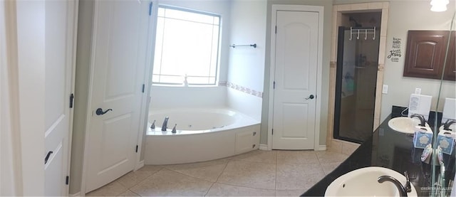 1805 Black Stone St, Edinburg, TX 78542 - bathroom featuring double vanity, a jetted tub, a stall shower, and tile patterned floors