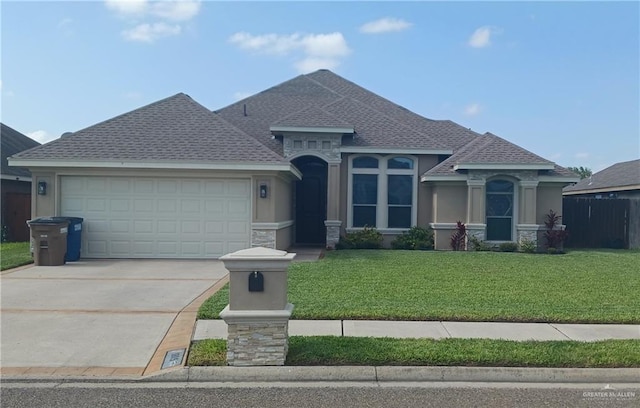 1805 Black Stone St, Edinburg, TX 78542 - view of front facade featuring concrete driveway, a shingled roof, an attached garage, stucco siding, and stone siding