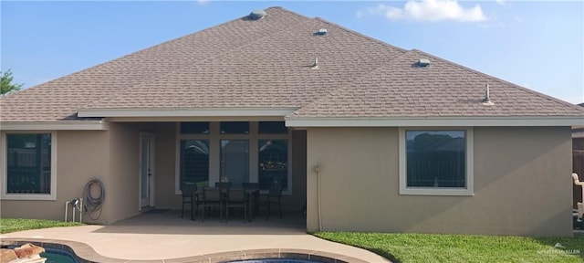 1805 Black Stone St, Edinburg, TX 78542 - back of property with a patio, roof with shingles, stucco siding, and an outdoor pool