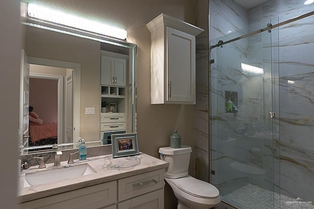 bathroom with toilet, vanity, and walk in shower