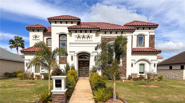 mediterranean / spanish-style house featuring a front yard