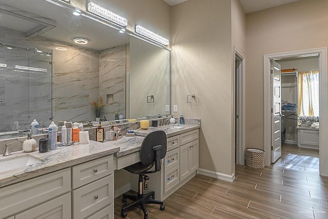 bathroom featuring a shower with door, vanity, and wood-type flooring