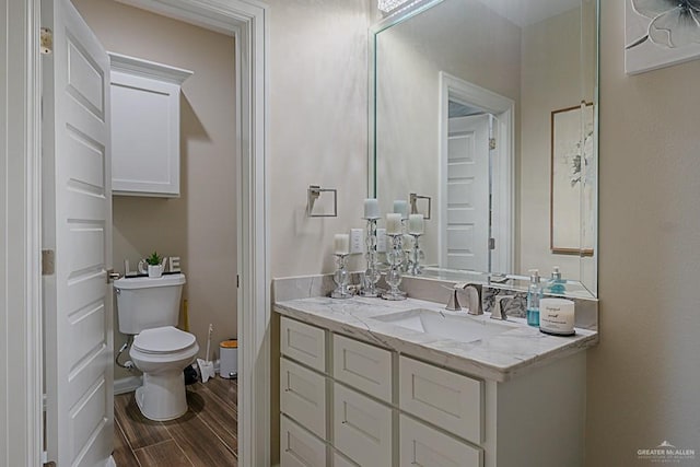 bathroom featuring hardwood / wood-style floors, vanity, and toilet