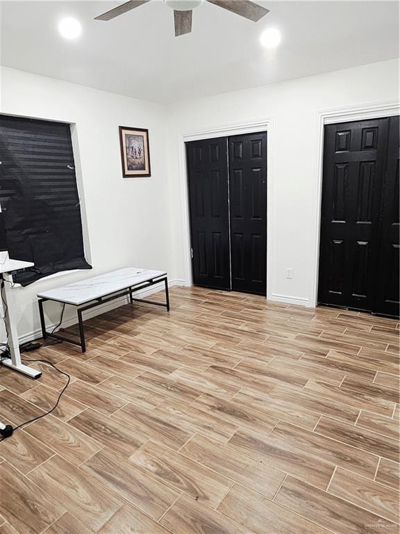 912 Max Dr, Elsa, TX 78543 - bedroom with light wood finished floors, multiple closets, baseboards, and ceiling fan