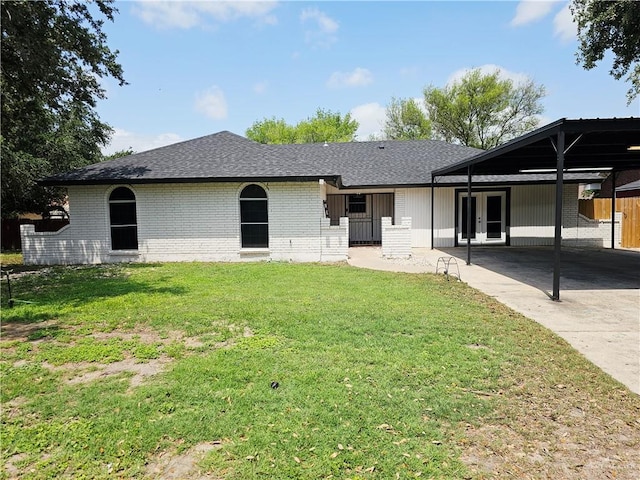 912 Max Dr, Elsa, TX 78543 - rear view of property with french doors, driveway, brick siding, a carport, and a shingled roof