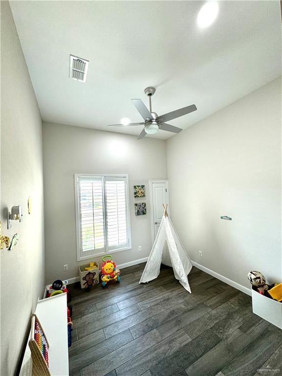 rec room featuring ceiling fan and dark wood-type flooring