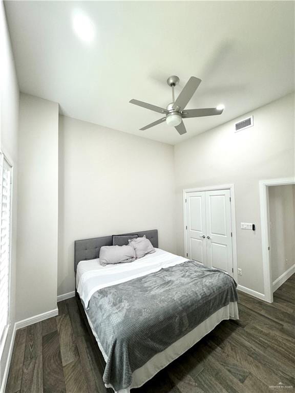 bedroom featuring a closet, ceiling fan, and dark wood-type flooring