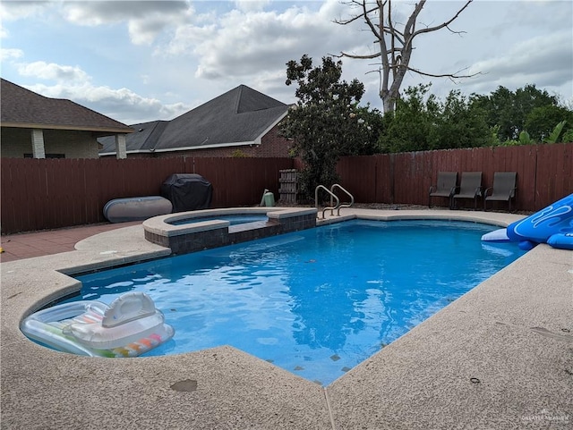 view of swimming pool featuring an in ground hot tub and grilling area