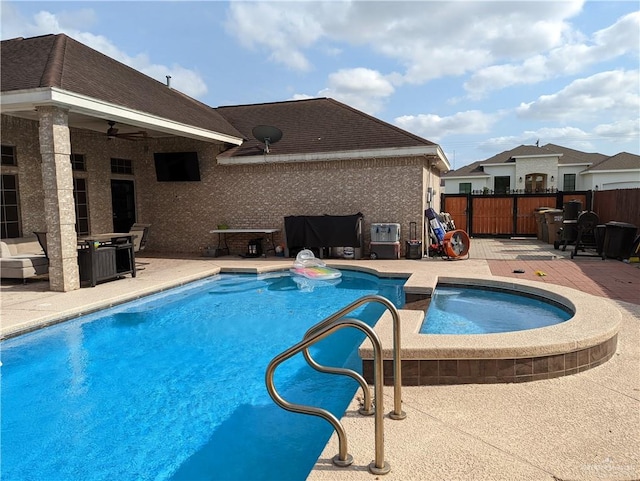 view of pool featuring ceiling fan, a patio area, and an in ground hot tub