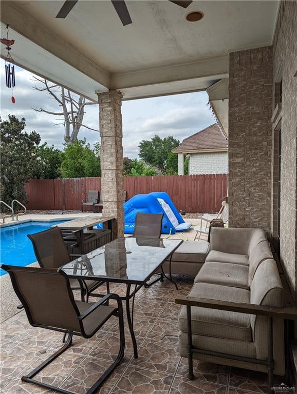 view of patio / terrace with a fenced in pool, outdoor lounge area, and ceiling fan