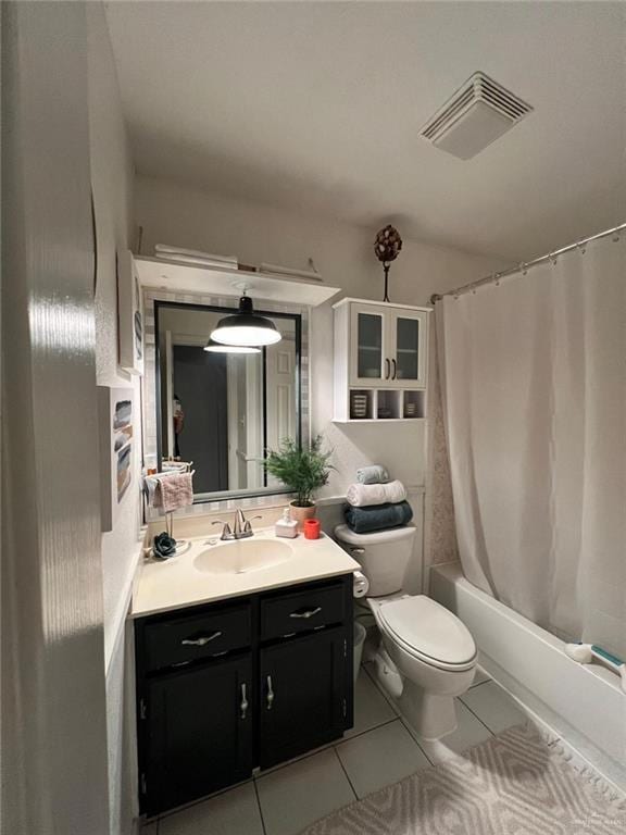 full bathroom with shower / bath combination with curtain, tile patterned floors, vanity, and toilet