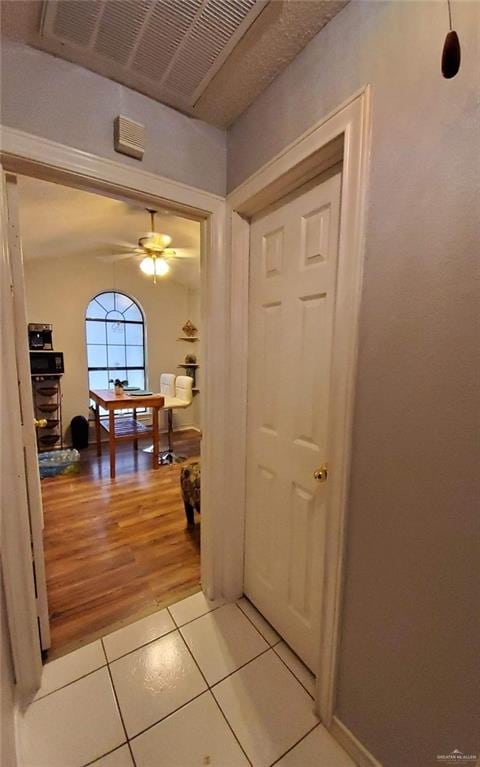 hall featuring light tile patterned floors