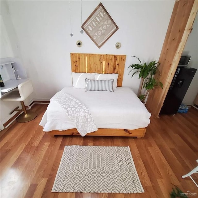 bedroom with hardwood / wood-style floors