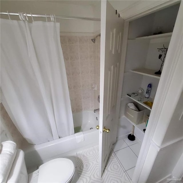 bathroom featuring tile patterned flooring, shower / tub combo with curtain, and toilet