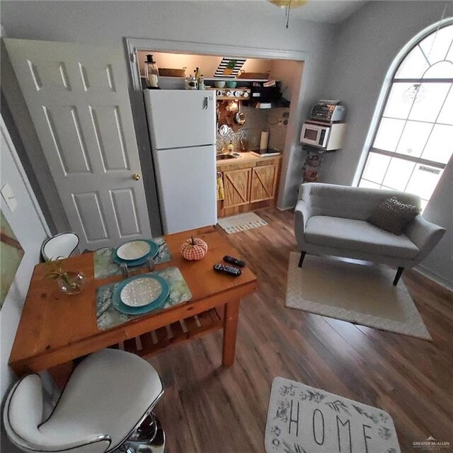 dining space with wood-type flooring and sink