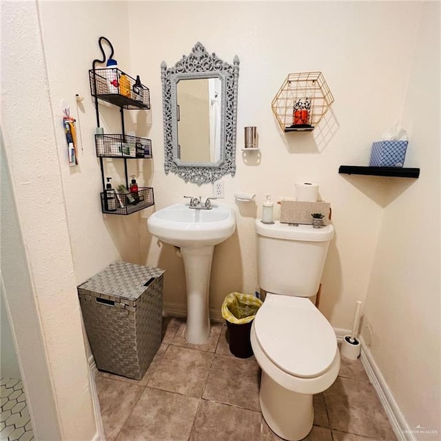 bathroom featuring tile patterned floors and toilet