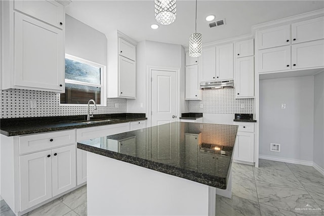 kitchen with white cabinetry and a kitchen island