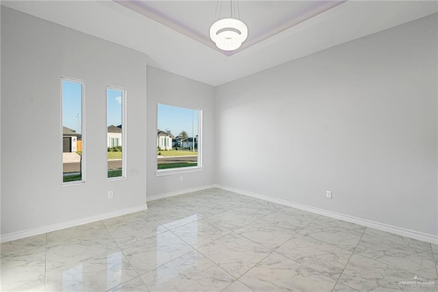 unfurnished room with a notable chandelier