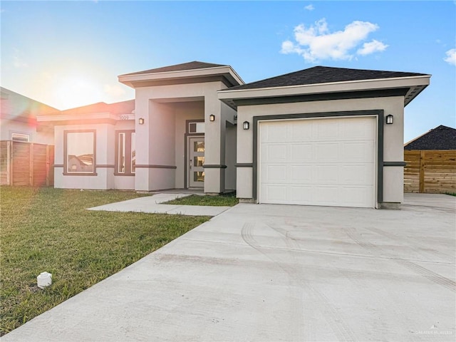 view of front of property with a front lawn and a garage