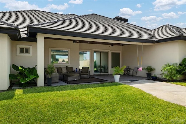 4552 Estancia Pkwy, Mcallen, TX 78504 - rear view of house with a ceiling fan, stucco siding, a tiled roof, outdoor lounge area, and a yard