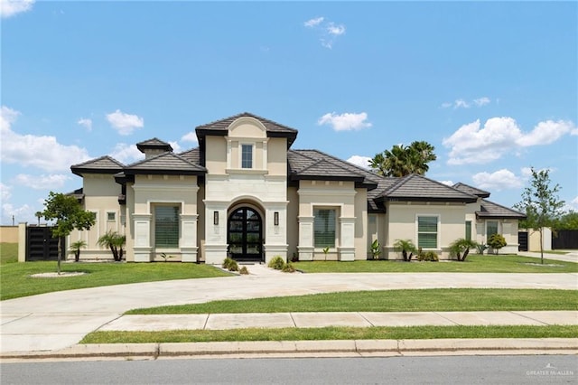 4552 Estancia Pkwy, Mcallen, TX 78504 - view of front of house with french doors, stucco siding, and curved driveway
