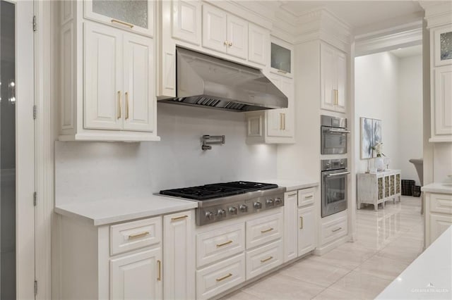 4552 Estancia Pkwy, Mcallen, TX 78504 - kitchen featuring appliances with stainless steel finishes, exhaust hood, light countertops, and white cabinets