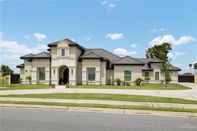 4552 Estancia Pkwy, Mcallen, TX 78504 - french country home featuring curved driveway and stucco siding