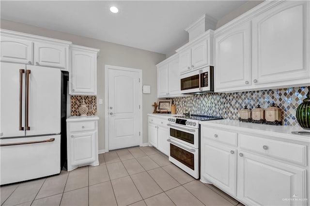 4816 Ensenada Ave, Mcallen, TX 78504 - kitchen with white appliances, white cabinets, light countertops, backsplash, and light tile patterned floors
