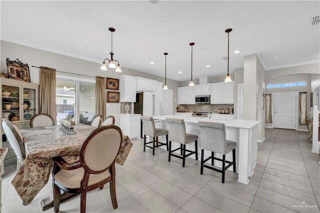 4816 Ensenada Ave, Mcallen, TX 78504 - dining space featuring crown molding, light tile patterned floors, and recessed lighting