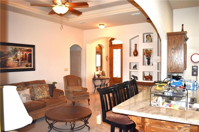 2515 E Q St, Hidalgo, TX 78557 - living room with arched walkways, ceiling fan, and a tray ceiling