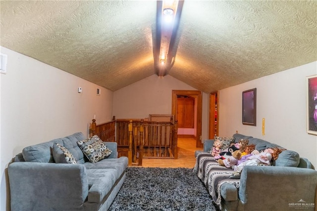 living room with vaulted ceiling, hardwood / wood-style floors, and a textured ceiling