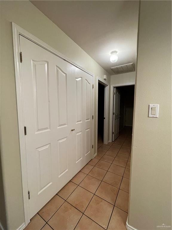 hallway featuring light tile patterned flooring