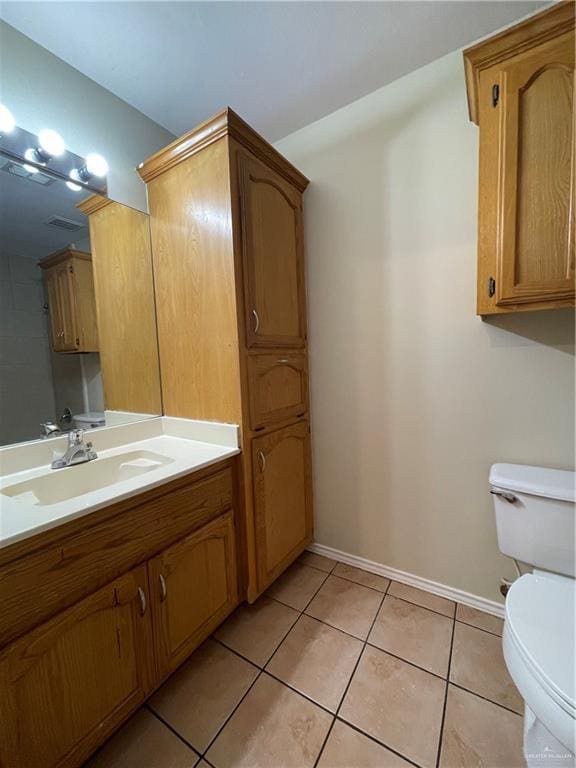 bathroom featuring tile patterned flooring, vanity, and toilet