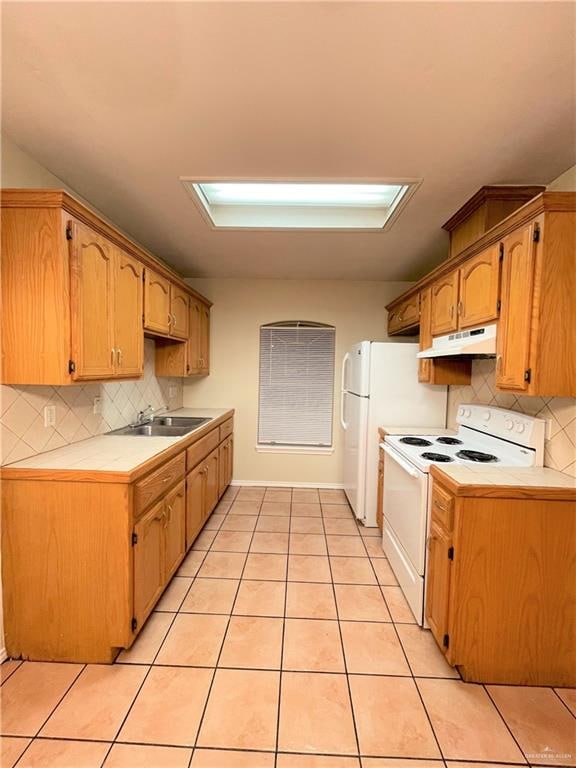 kitchen featuring decorative backsplash, light tile patterned flooring, white range with electric cooktop, and sink