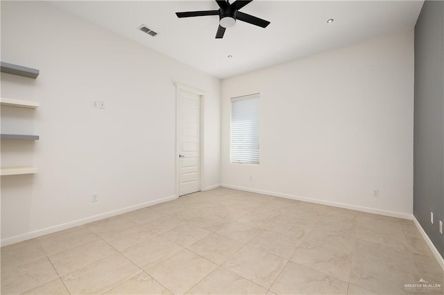 tiled spare room with built in shelves and ceiling fan