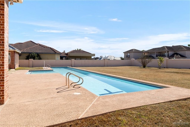 view of swimming pool featuring a yard and a patio area