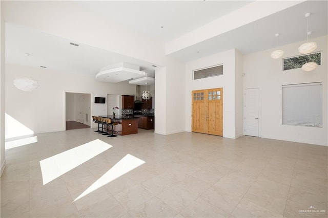 living room featuring a towering ceiling