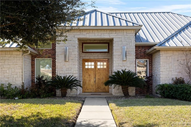 doorway to property with a lawn