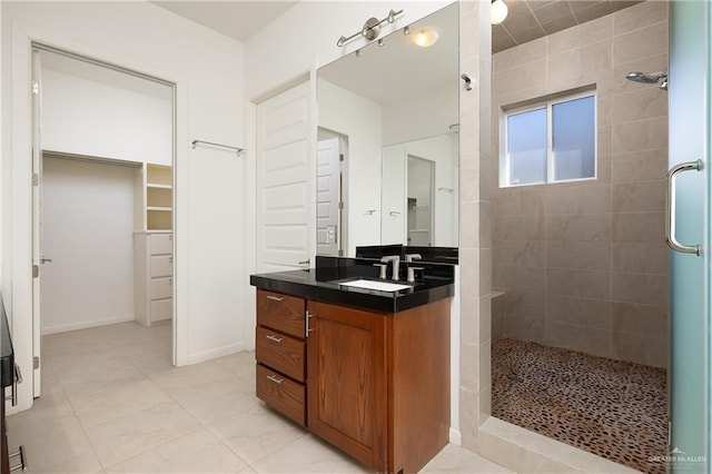 bathroom featuring vanity and tiled shower