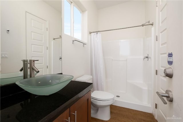 bathroom featuring a shower with curtain, vanity, toilet, and hardwood / wood-style floors