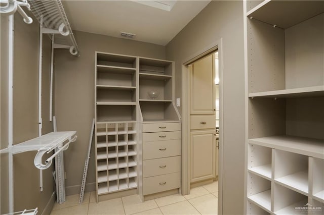 spacious closet featuring light tile patterned floors