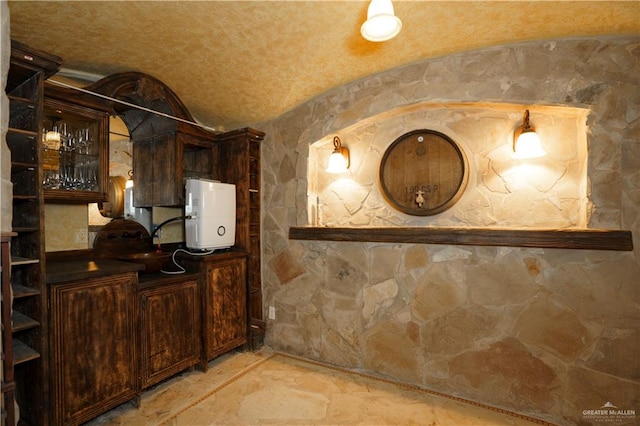 wine cellar featuring vaulted ceiling