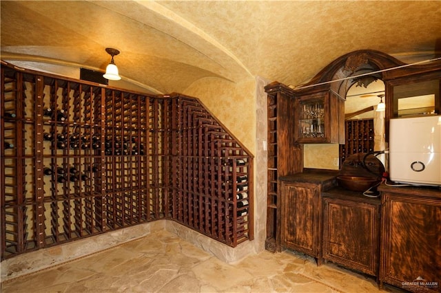 wine area featuring vaulted ceiling