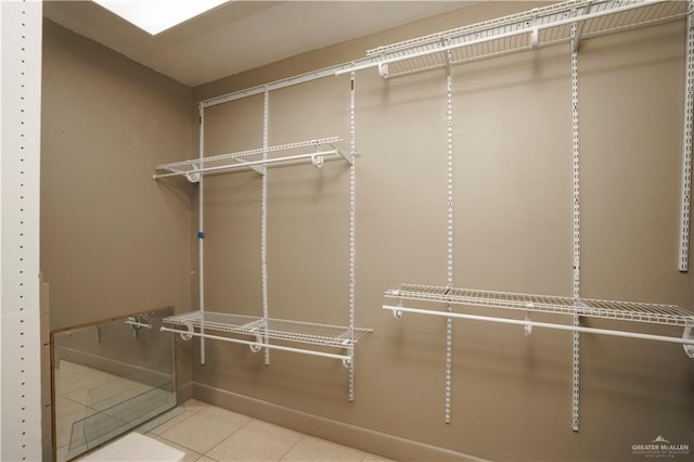 walk in closet featuring tile patterned flooring