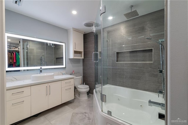 full bathroom featuring shower / bath combination with glass door, vanity, toilet, and tile patterned flooring