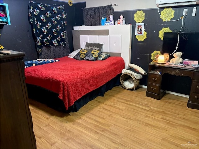 609 S 24th St, Donna, TX 78537 - bedroom featuring a wall unit AC and wood finished floors