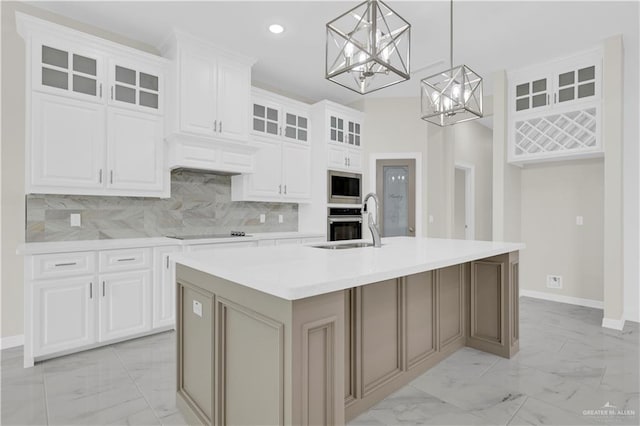 3007 S Livingston St, Edinburg, TX 78542 - kitchen featuring light marble finish flooring, stainless steel appliances, a chandelier, baseboards, and an island with sink