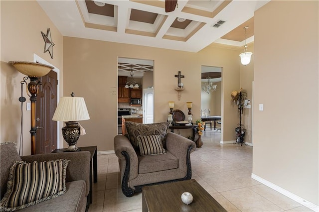 tiled living room with a chandelier, beam ceiling, and coffered ceiling