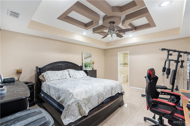 bedroom featuring ceiling fan, a raised ceiling, light tile patterned floors, and ensuite bath