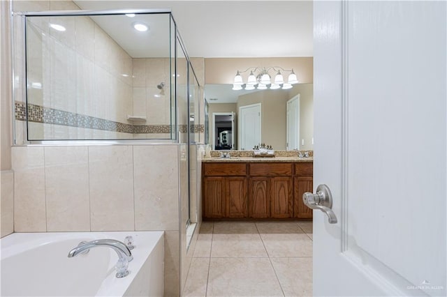 bathroom with tile patterned floors, vanity, and shower with separate bathtub